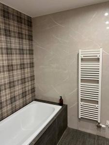 a bathroom with a bath tub in a room at Nové bývanie v centre Košíc. in Košice +14 photos