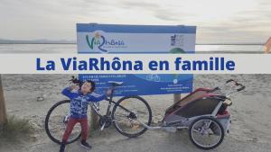 a young boy standing next to a bike on the beach at HOTEL DE LA PAIX Lyon Sud Givors in Givors