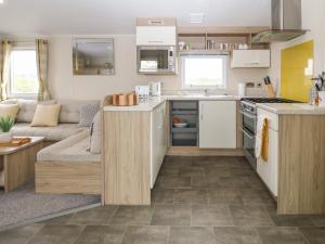eine Küche und ein Wohnzimmer in einem Wohnwagen in der Unterkunft Caravan at Boderw in Holyhead
