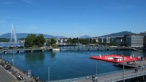 a river with a red boat in the water at The Ambassador in Geneva