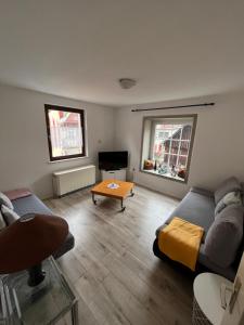 a living room with a couch and a coffee table at Ferienwohnung Schlossberg 2 in Wirsberg