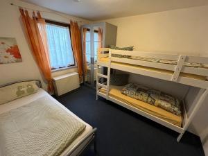 a bedroom with two bunk beds and a window at Ferienwohnung Schlossberg 2 in Wirsberg