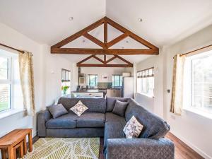 a living room with a couch and a table at Willow Cottage - Uk38484 in Saltash