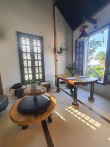 a living room with two tables and a couch at Pousada Lua de Charme in Canoa Quebrada