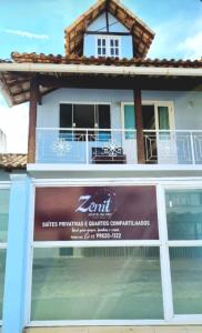 a building with a sign in front of it at Zênit Hostel da Cris in Cabo Frio