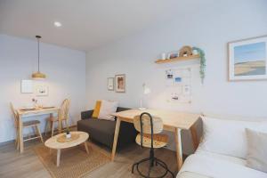 a living room with a couch and a table at Minimal Cozy Room near Chatuchak Weekend Market #1 in Bangkok