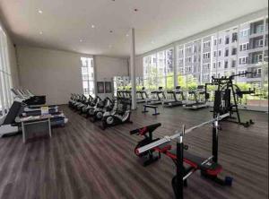 a gym with a bunch of treadmills and machines at Minimal Cozy Room near Chatuchak Weekend Market #1 in Bangkok