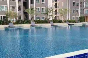 a large swimming pool with chairs in front of a building at Minimal Cozy Room near Chatuchak Weekend Market #1 in Bangkok
