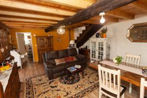 a living room with a couch and a table at Magnolias Cottage in Lousã