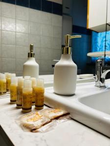 a bathroom counter with bottles of soap and a sink at Come a casa tua in Falconara Marittima