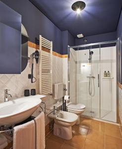 a bathroom with a sink and a toilet and a shower at URBANAUTS STUDIOS Minelli in Trieste