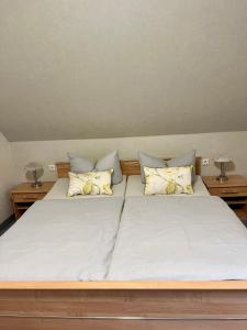 a bedroom with a large bed with two pillows at Ferienwohnung Holzerland in Patzig