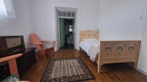 a bedroom with a bed and a tv in it at Very Typical - Alojamento Local in Elvas