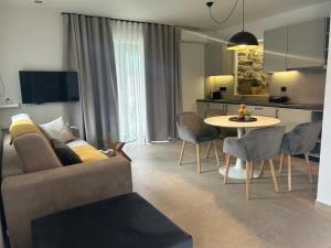 a living room with a couch and a table at Piedra Luxury Apartments in Nafplio
