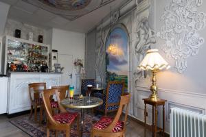 a dining room with a table and chairs at Hotel Le Beffroi in Dreux