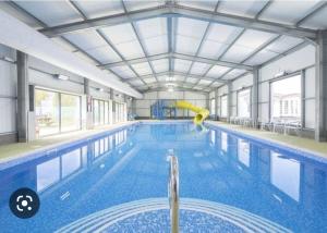 a large swimming pool with a pool noodle in it at Seawick Holiday Park in Saint Osyth