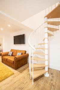 a living room with a staircase and a couch at Cottage Buttercup Yarm in Stockton-on-Tees