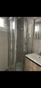 a shower with a glass door next to a sink at Casa Ricordi in Vietri sul Mare