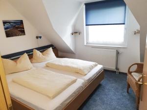 a bedroom with two beds and a window at Skipper in Dorum Neufeld +37 photos