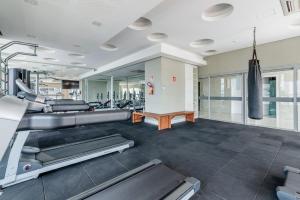 a fitness room with treadmills and a gym at Trend Nova Carlos Gomes - 406 in Porto Alegre