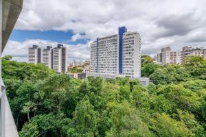 a city skyline with tall buildings and trees at Trend Nova Carlos Gomes - 406 in Porto Alegre