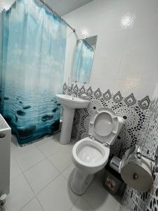 a bathroom with a toilet and a sink at OLD SAFARI HOTEL make yourself at home in Bukhara