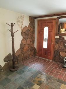 a room with a stone wall and a wooden door at Your comfy home in Colorado Springs in Colorado Springs