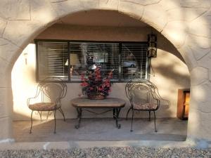 a patio with a table and two chairs and a window at Your comfy home in Colorado Springs in Colorado Springs