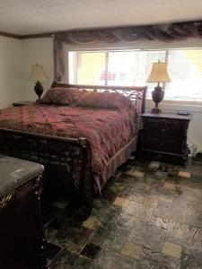 a bedroom with a bed and two lamps and a window at Your comfy home in Colorado Springs in Colorado Springs