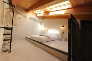 a bedroom with a bed in a loft with a skylight at Bene39 in Turin