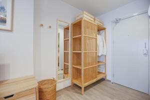 a room with a closet with wooden shelves at Minimal Cozy Room near Chatuchak Weekend Market #2 in Bangkok