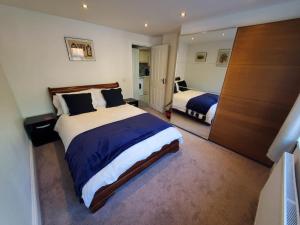 a large bedroom with two beds and a closet at Central Windsor 2 bedroom flat with free parking in Windsor