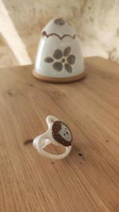 a toy animal figurine with a cookie on a table at Amalò Guest House in Bari +23 photos