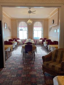 a dining room with tables and couches and chairs at The Langham in Weymouth