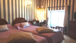 Postel nebo postele na pokoji v ubytování Hotel Le Clos du Montvinage