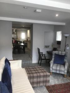 a living room with a couch and chairs and a table at 40 Newgate Barnard Castle -Central Location - Court Yard - Dog Friendly - Sleeps 7 - Wood Burner - Complimentary Logs & Wine - Smart TV in Barnard Castle