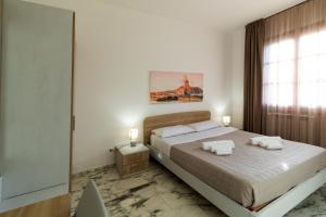 een slaapkamer met een groot bed en een raam bij Il Glicine in Marsala