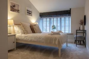 um quarto com uma cama grande e uma janela em Gardener's Cottage em Chepstow