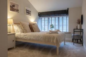 a bedroom with a large bed and a window at Gardener's Cottage in Chepstow