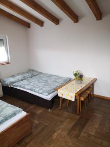 a room with a bed and a table in it at Ceremoniár in Poľný Kesov