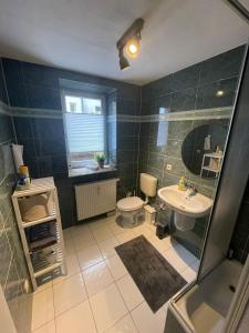 a bathroom with a sink and a toilet at Ruhiges Apartment im Herzen von Gera in Gera