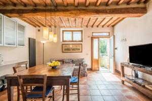 a kitchen and dining room with a table and chairs at Agriturismo La Magione in Quercegrossa