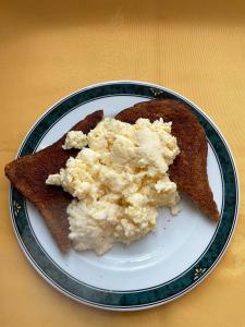 a plate of food with eggs on top of toast at The Langham in Weymouth