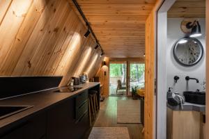 a kitchen with wooden walls and wooden counters at Kabinka Mátra in Pásztó