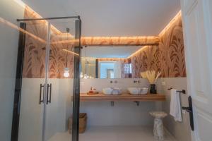 a bathroom with a shower and a mirror at Casa de la Acequia by Florentia Homes in Granada