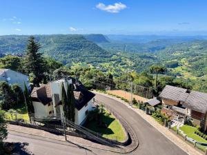 a house on a hill with a winding road at Apartamento Vale Quilombo 2 dorm by Achei Gramado in Gramado