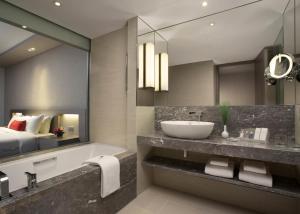 Ένα ή περισσότερα κρεβάτια σε δωμάτιο στο Carlton Hotel Singapore