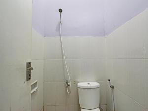 a bathroom with a shower with a toilet in it at OYO 92459 Cahyo Kost 2 in Semarang