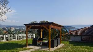 a gazebo with benches in a yard at Villa Senegačnik in Portorož