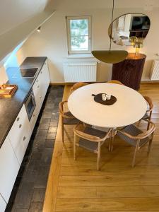 Una cocina y un comedor con mesa y sillas. en Nuits De Mer, en De Haan